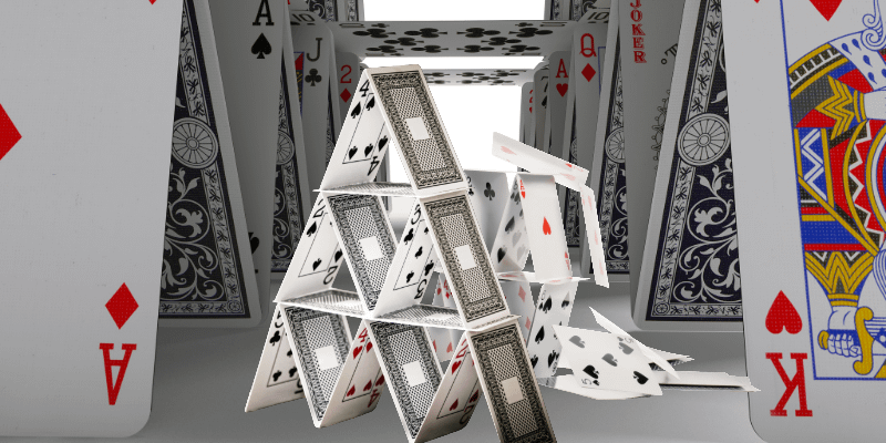 House of cards collapsing illustrating the trust trap fraudsters build through unverified referrals